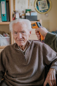 Portrait of man sitting at home