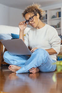 Young woman using laptop at home