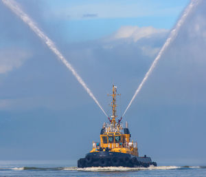 Fire hose boat spraying water on kamchatka on paciic ocean