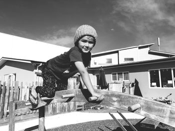 Side view portrait of boy playing at playground during sunny day