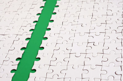 Close-up of jigsaw puzzle on green background