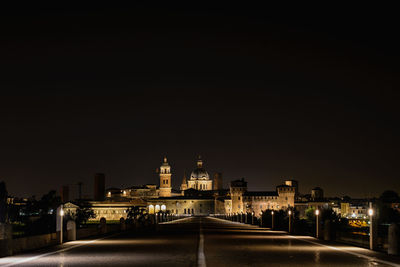 Illuminated buildings against sky at night