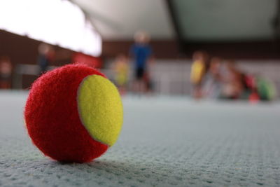 Close-up of red tennisball on court