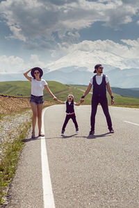 Fashionable family in hats walks along the road in nature at mount everest