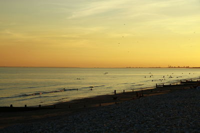 Scenic view of beach against sky during sunset