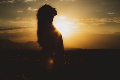 Side profile of woman at golden hour