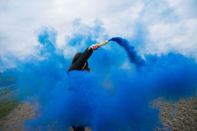 Woman standing amidst distress flare