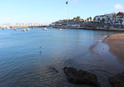 View of sea and buildings against sky