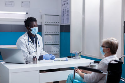 Doctor having discussion with patient in hospital