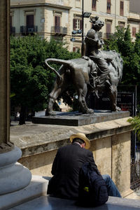 Statue against trees