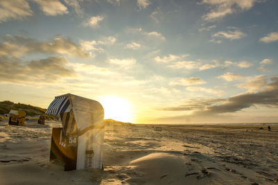 Scenic view of beach against sky during sunset