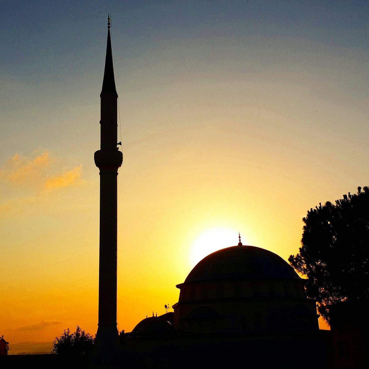 sunset, architecture, building exterior, built structure, orange color, silhouette, religion, place of worship, spirituality, dome, sky, low angle view, church, clear sky, sun, copy space, travel destinations, outdoors