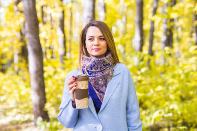 Portrait of a smiling young woman standing outdoors