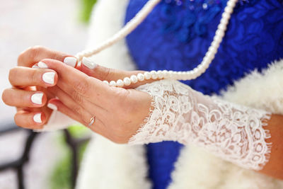 Cropped hand of woman holding rope