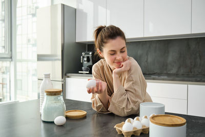 Portrait of cute girl drinking coffee at home