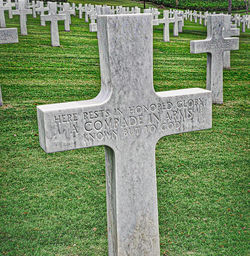 View of cross on grass in park