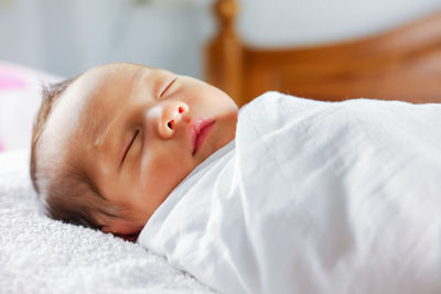 Cute baby sleeping on bed