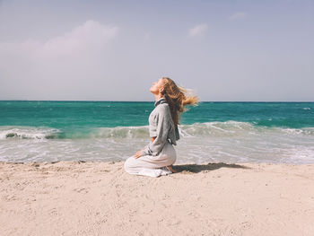 Full length of woman at beach against sky