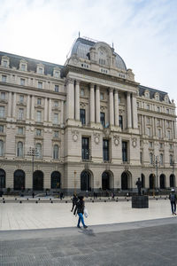 People walking in front of building