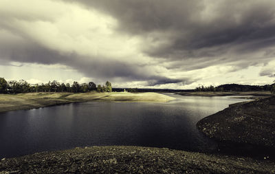 View of lake against cloudy sky