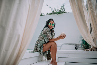 Portrait of young woman in sunglasses