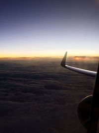 Cropped image of airplane flying over sea