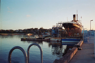 View of marina at harbor against clear sky