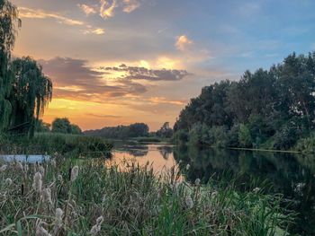 Scenic view of lake against sky during sunset