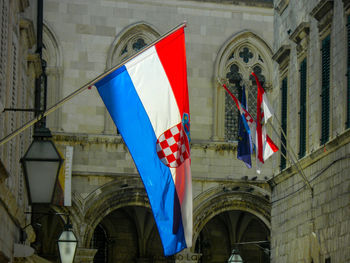 Low angle view of flag against building