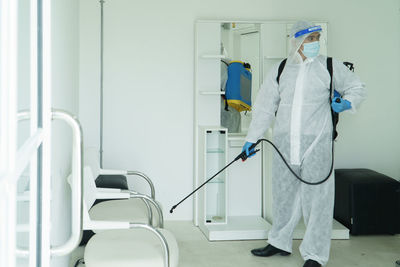 Midsection of man standing in corridor