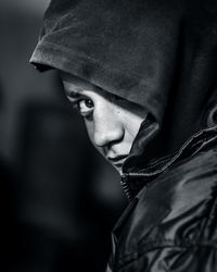 Close-up portrait of teenage boy wearing hooded shirt