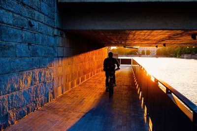 Rear view of woman walking on bridge