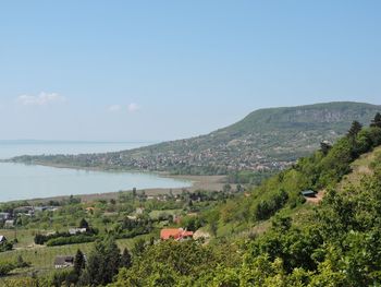 Scenic view of sea and mountains against sky