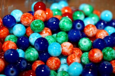 High angle view of colorful beads in container