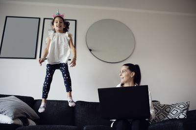 Mother and daughter on sofa