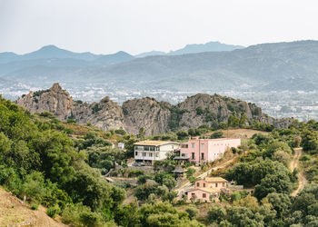 High angle view of houses and mountains against clear sky