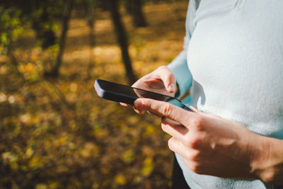 Beautiful girl uses phone for fitness or yoga.