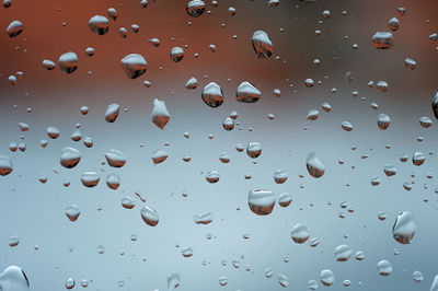 Full frame shot of raindrops on glass window