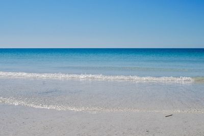 Scenic view of sea against clear blue sky