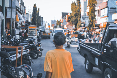 Rear view of man on street in city