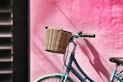 Close-up of bicycle leaning on wall