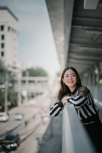 Portrait of a smiling young woman in city