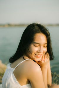 Portrait of a beautiful young woman with eyes closed