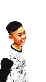 Portrait of boy standing against white background