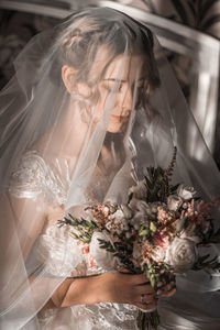 Portrait of young woman with bouquet