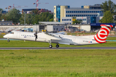 Airplane on runway against sky