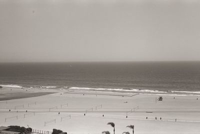 People at beach against sky