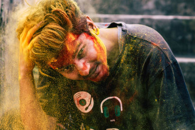 Portrait of young man covered with powder paint