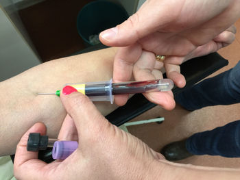 Doctor taking blood sample from patient