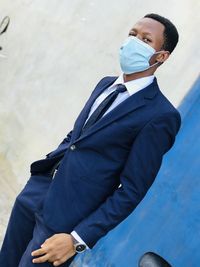 Young man wearing mask standing outdoors